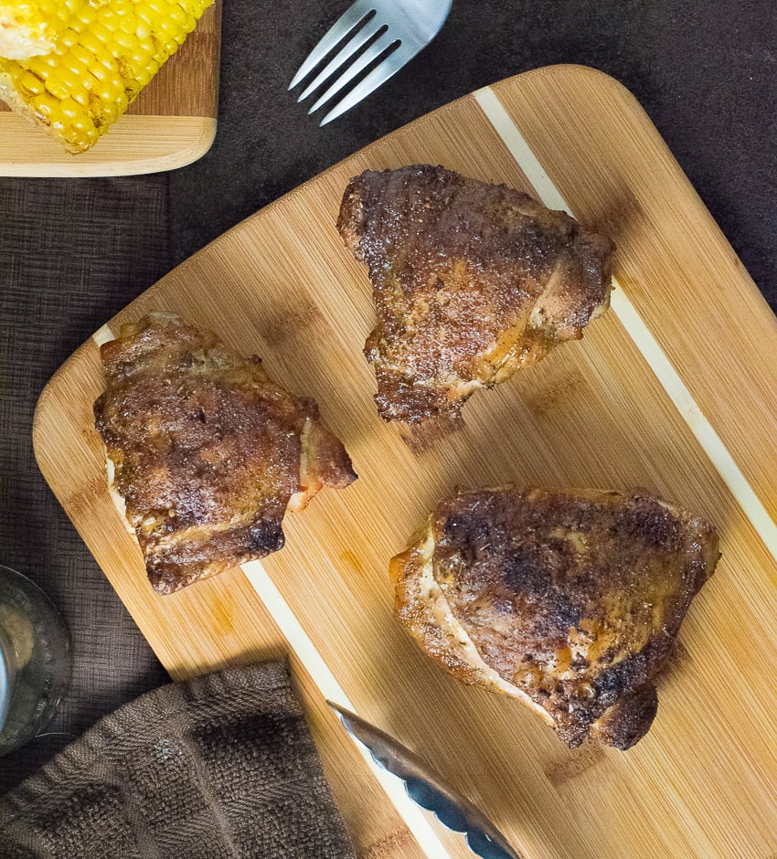 Smoked chicken legs on cutting board.