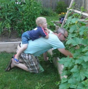 My step son riding on my back while I garden