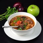 Hearty venison stew recipe in white bowl.