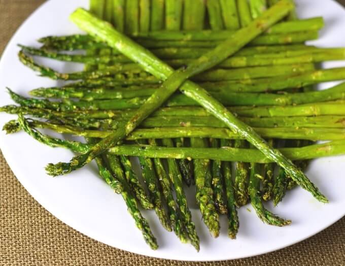 Close up look at roasted asparagus on a plate.