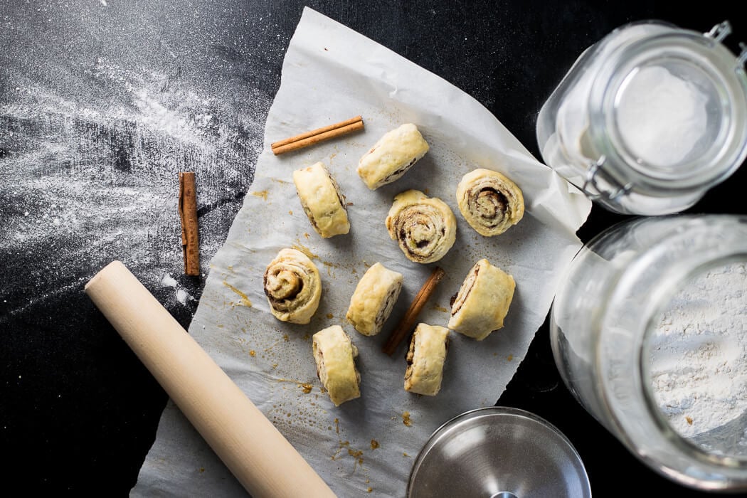 Pie Dough Cinnamon Rolls on wax paper.