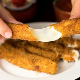 Deep fried mozzarella sticks being stretched