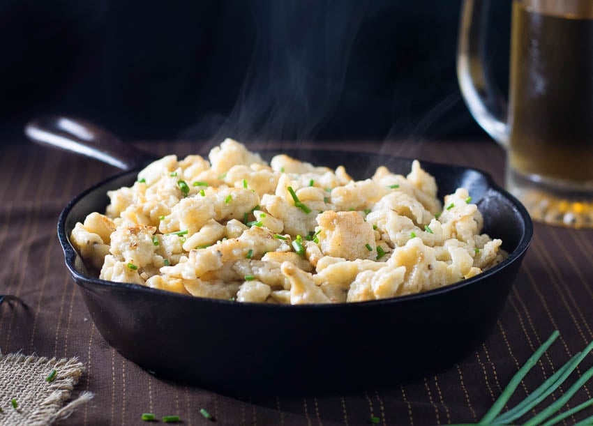 Homemade spaetzle steaming in pan.