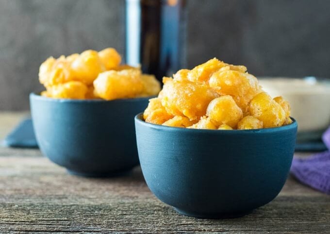 Two black bowls of Beer Battered Deep Fried Cheese Curds.