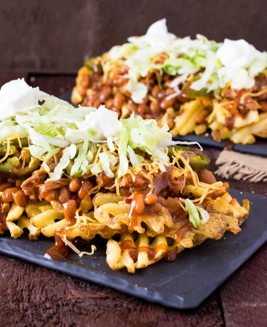 BBQ Irish Nachos piled on black tray.