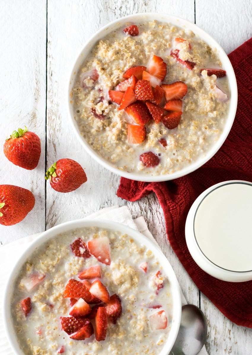 Two bowls of strawberries and cream oatmeal.