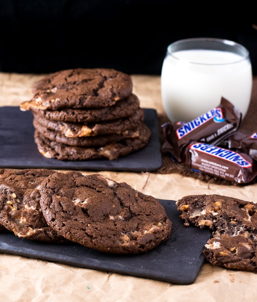 Triple Chocolate Snickers Cookies on black tray.