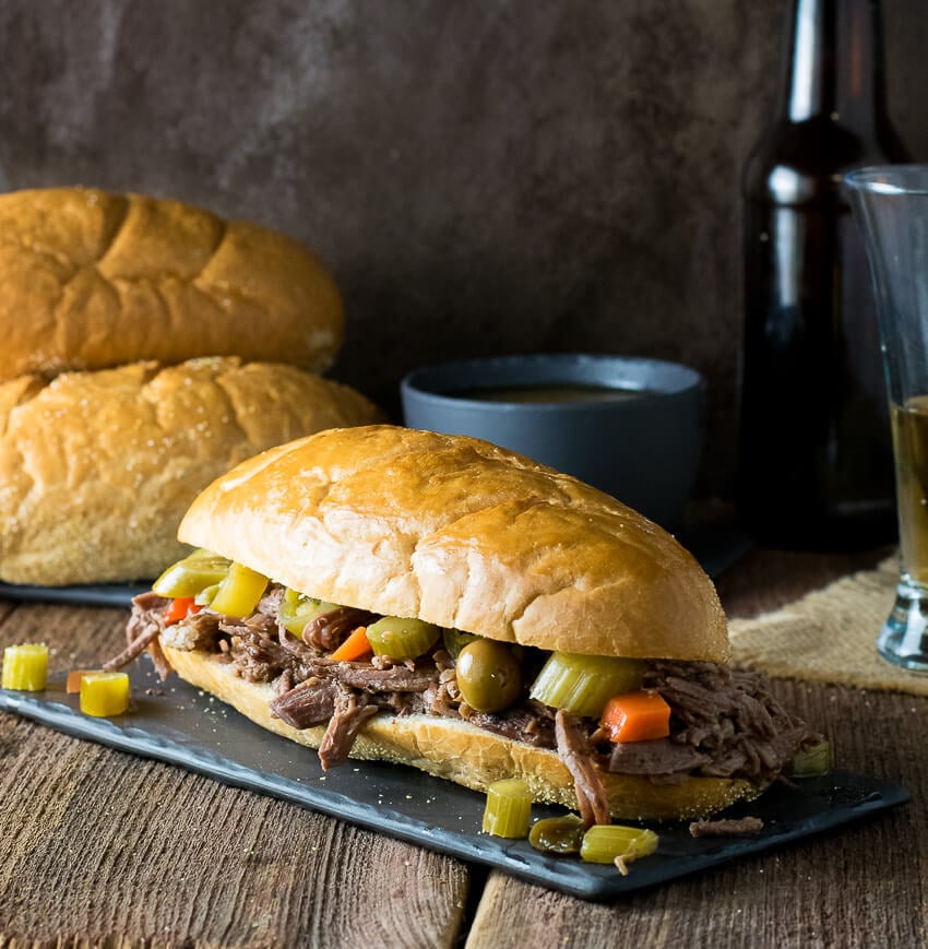 Crock Pot Italian Beef Sandwich Chicago Style on dark platter.