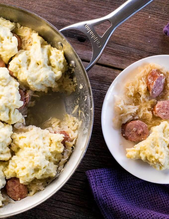 Sauerkraut and Dumplings viewed from above on a plate and in a pan.