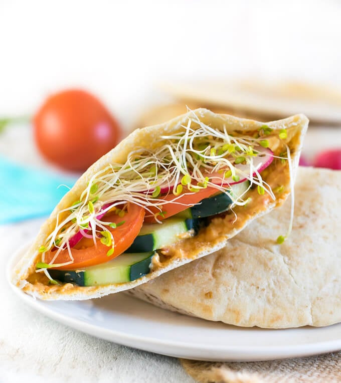 Close up view of veggie hummus pita sandwich