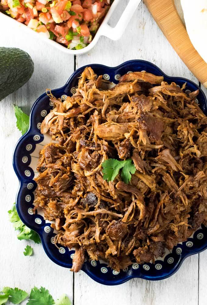 Shredded pork carnitas on plate.