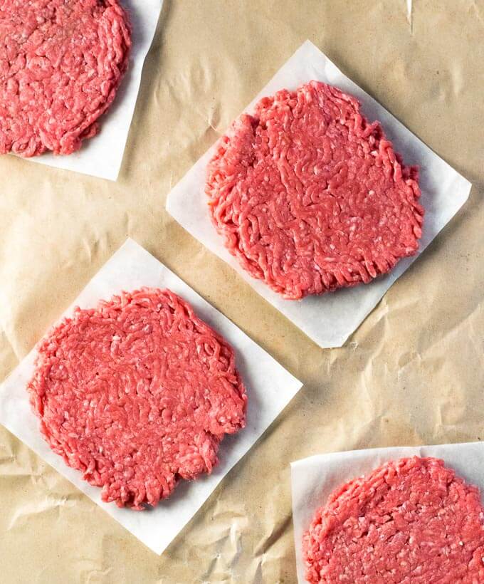 Restaurant style fresh burger patties on wax paper