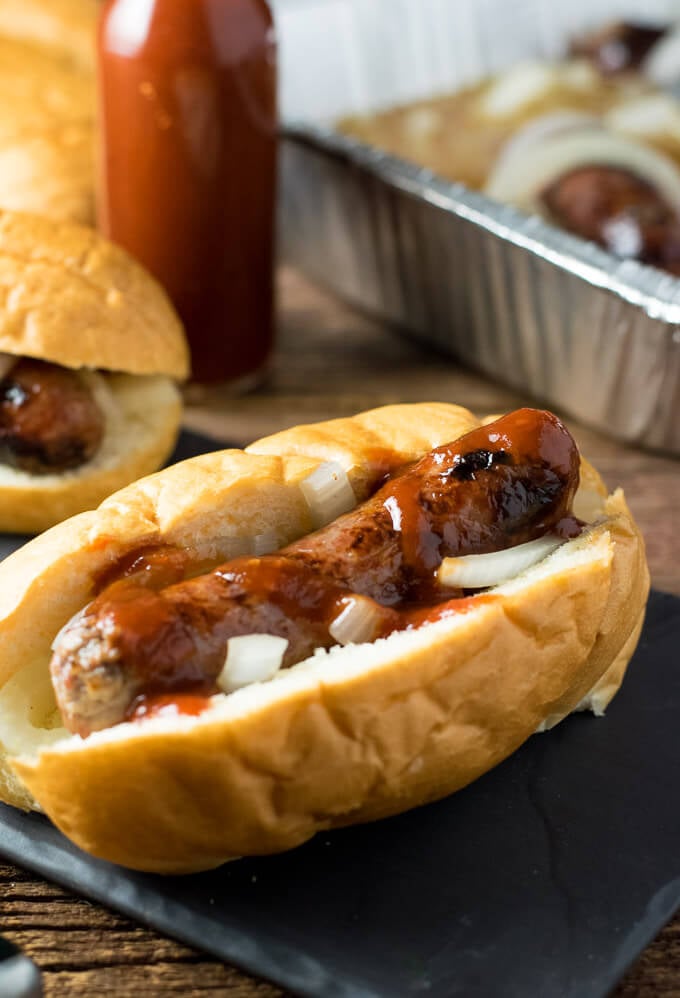 Perfectly Cooked Brat on bun with onions.