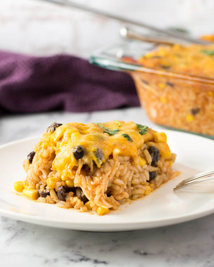 Easy Chicken Enchilada Casserole on white plate with fork.