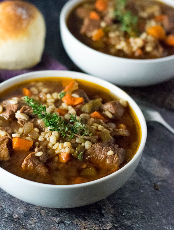 Beef and Barley Soup close up with sprig of thyme.