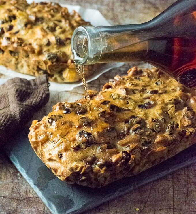 Pouring brandy on homemade fruitcake.