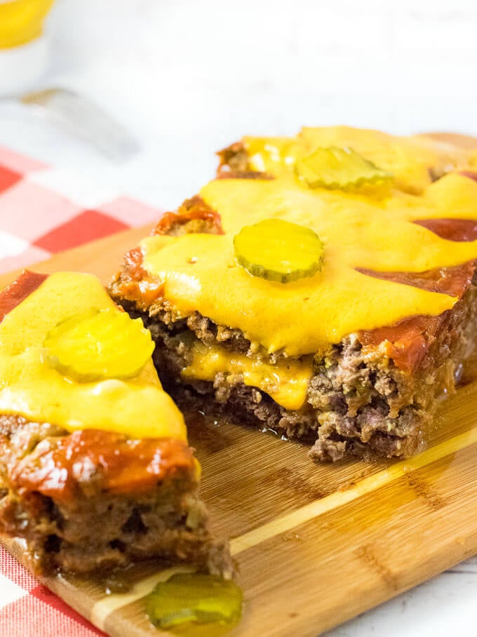 Serving sliced cheeseburger meatloaf.