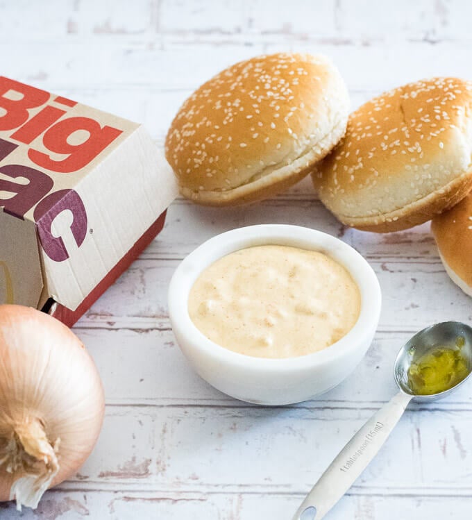 Big Mac Sauce in bowl next to big mac container and hamburger buns.