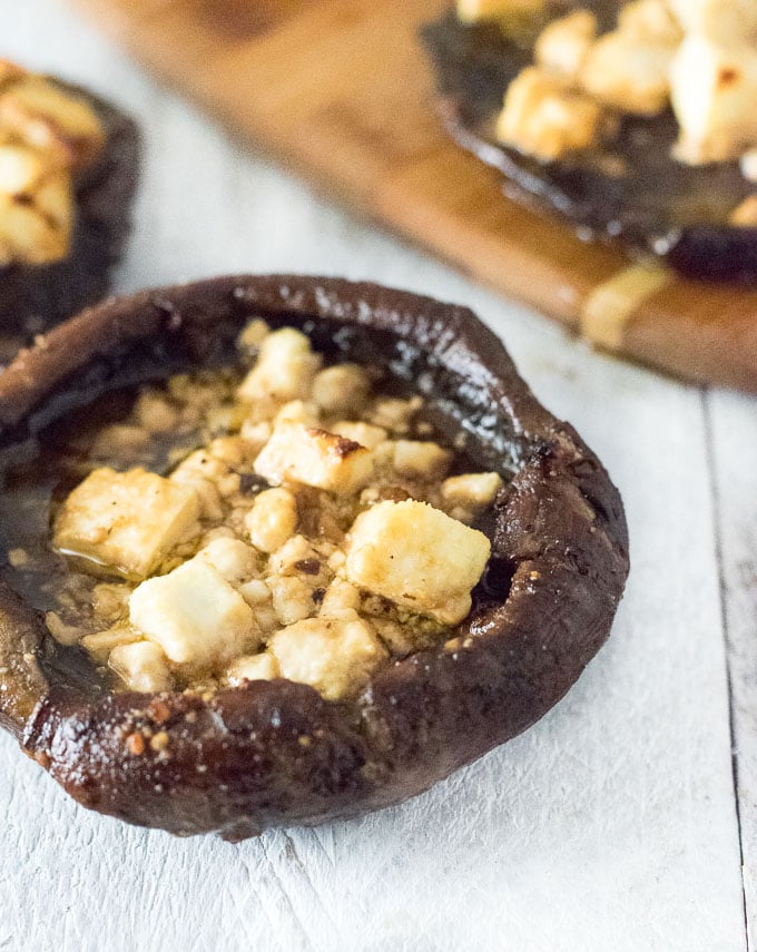 Serving baked portobello mushrooms.