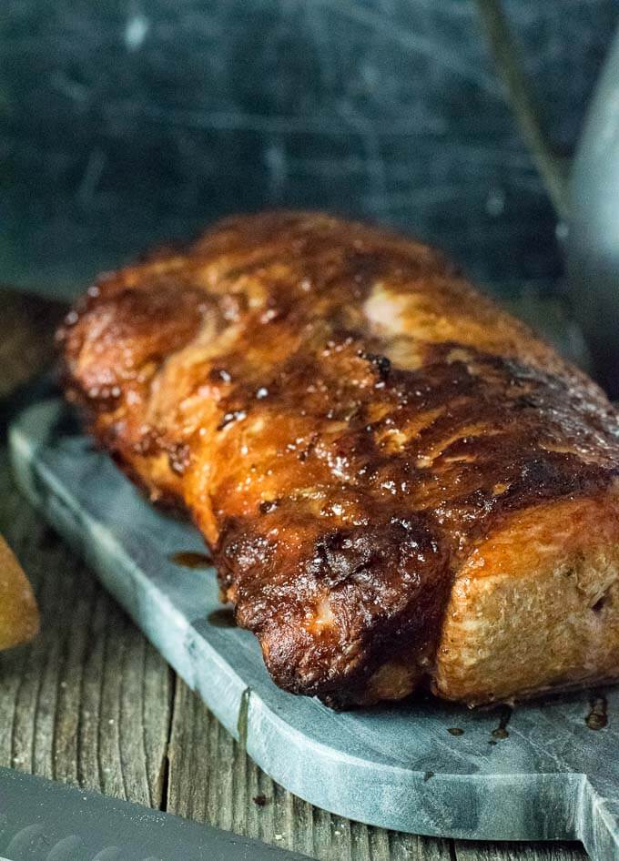 Grilled pork loin on serving tray.