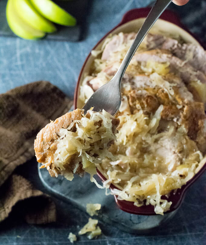 Slow cooker Pork and Sauerkraut being eaten with a fork.