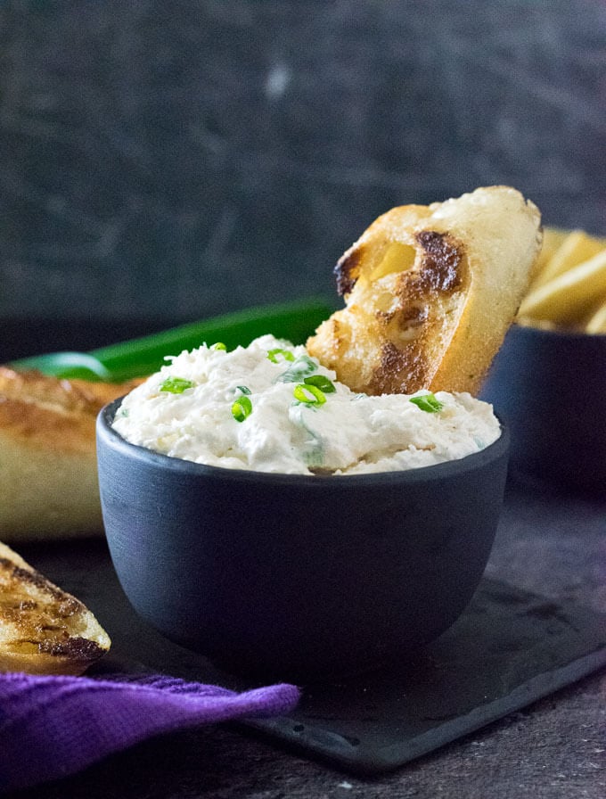 Serving cold crab dip with baguette.