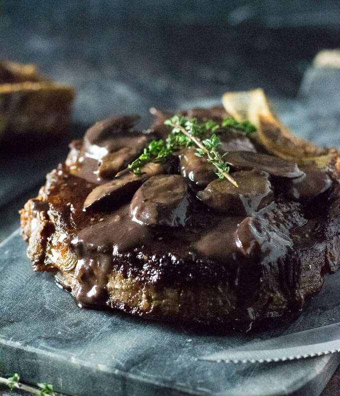 Topping steak with mushroom sauce.