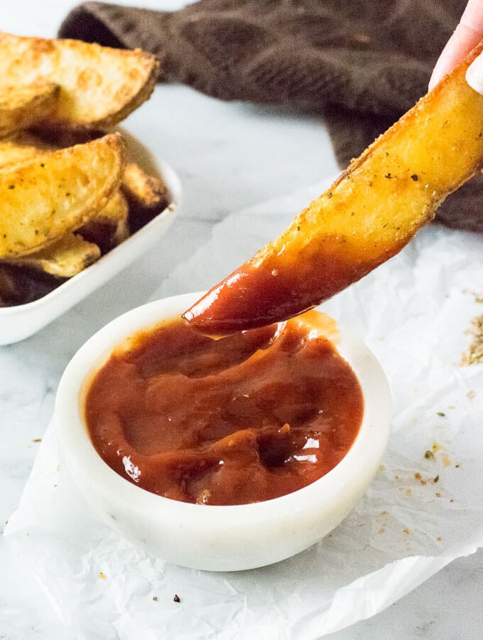 Serving steak fries with dipping sauce.