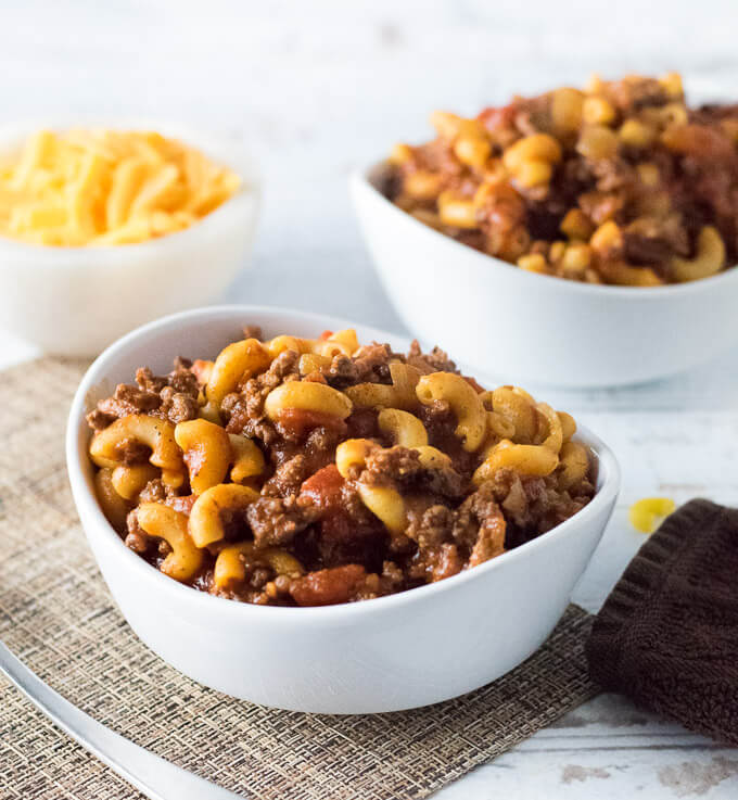 Serving Beefaroni with shredded cheese.