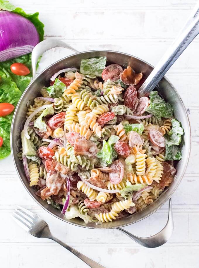 Bacon lettuce and tomato pasta salad in a pot shown from above.