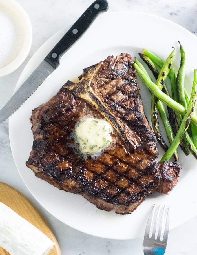 Garlic herb compound steak butter on grilled steak.