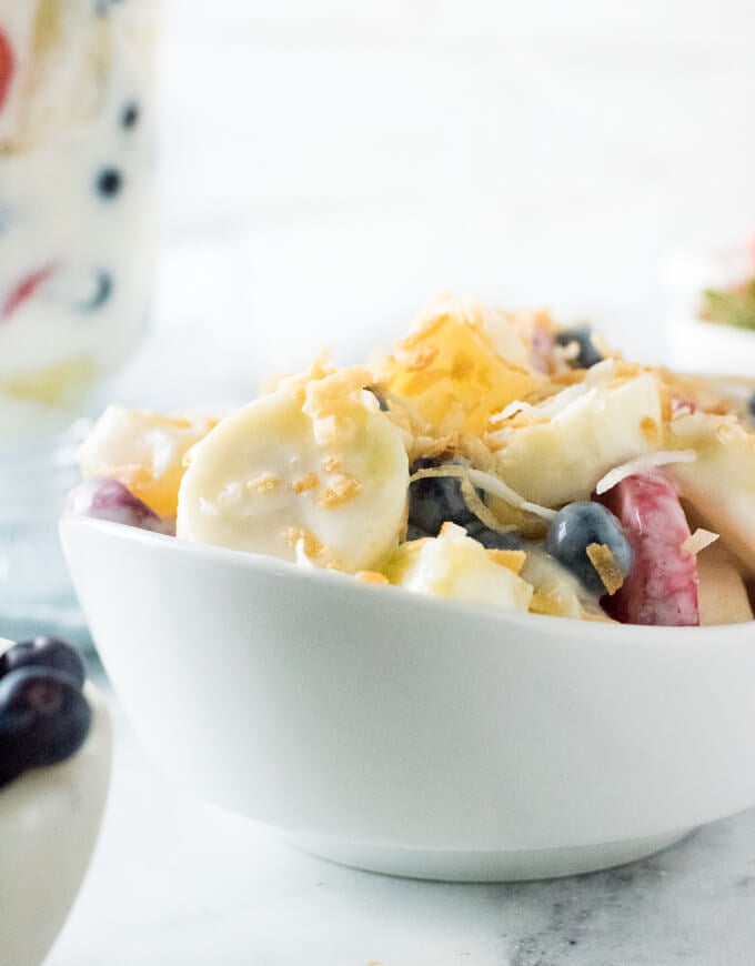 Serving fresh fruit Salad with yogurt dressing.