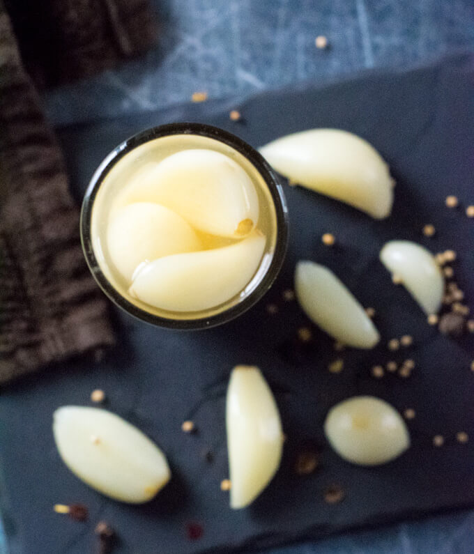 Pickled garlic in glass jar.