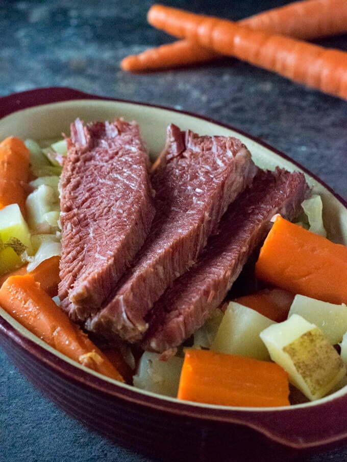 Sliced corned beef in dish with vegetables