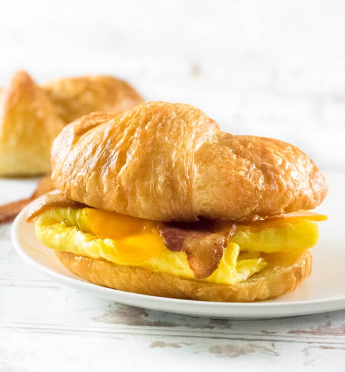 Croissant Breakfast Sandwich shown close up with white background.