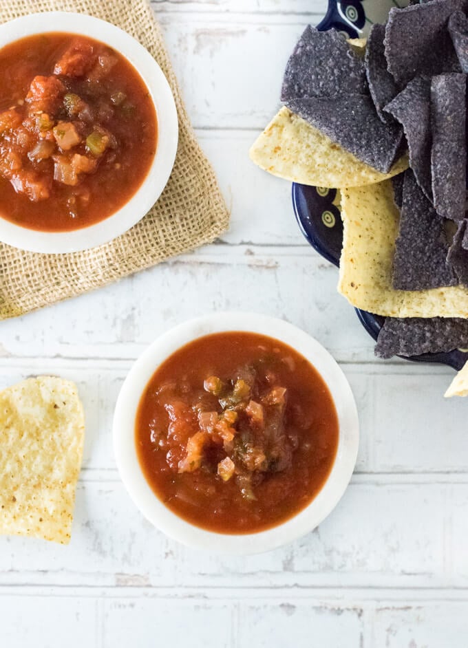 Two bowls of salsa with tortilla chips