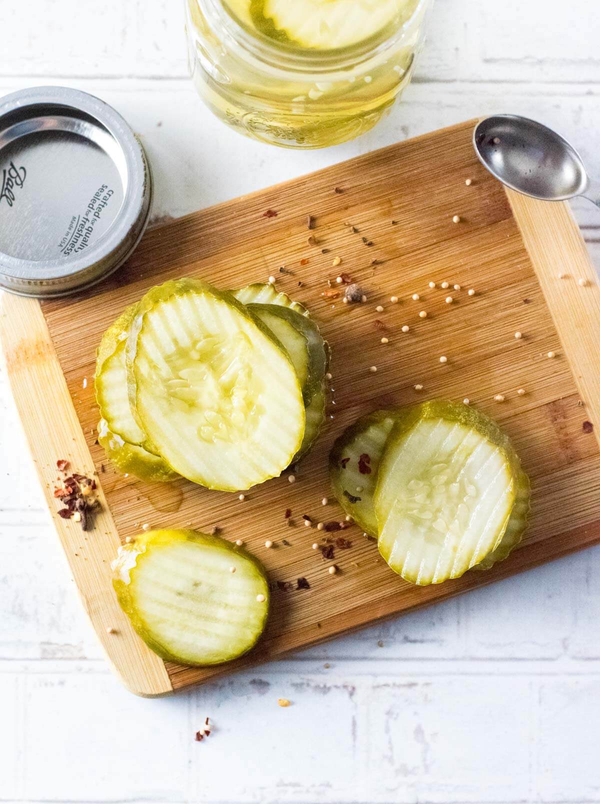 Sliced pickles on a cutting board viewed from above.
