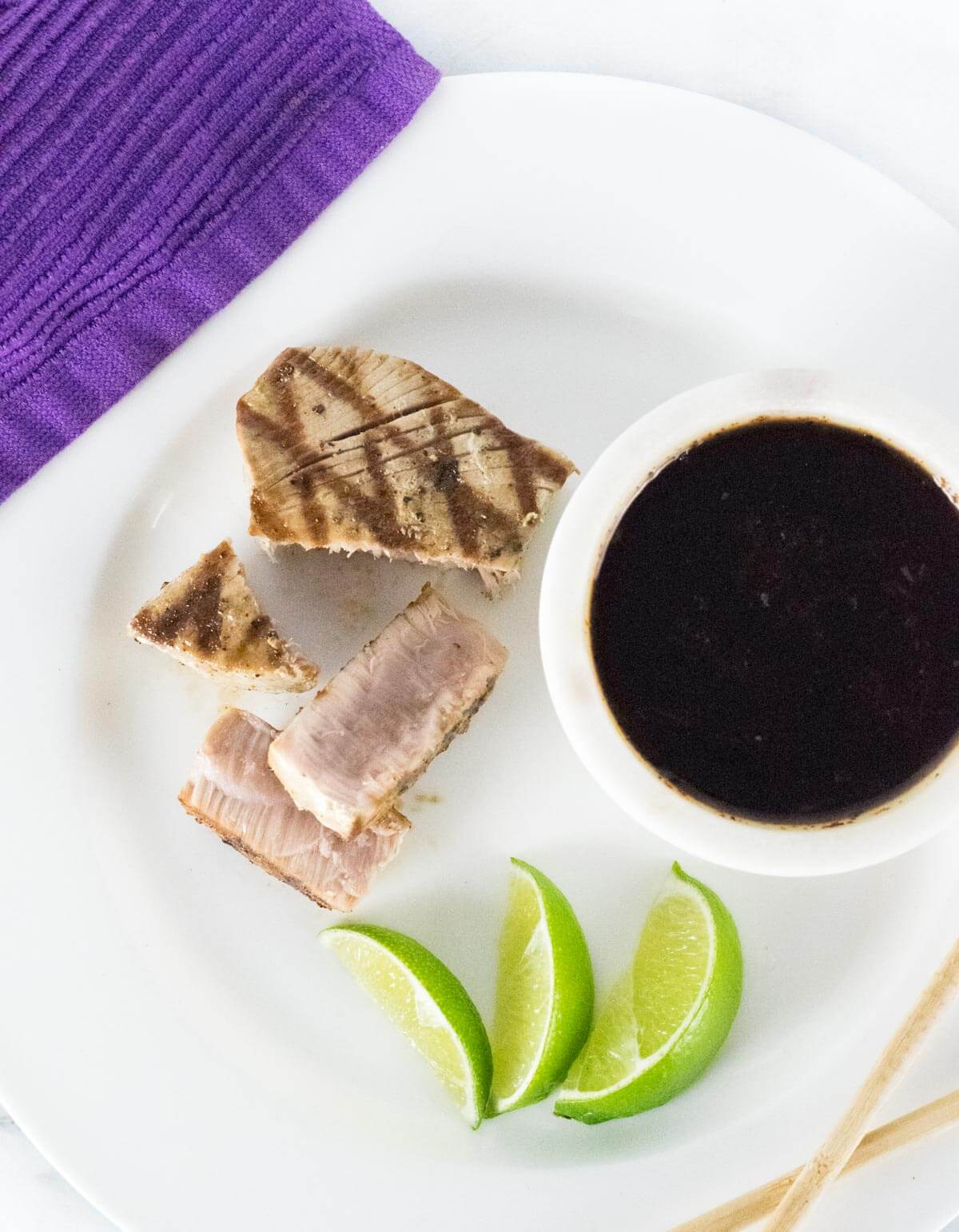 Sliced grilled tuna steak with Dipping Sauce served with fresh lime.