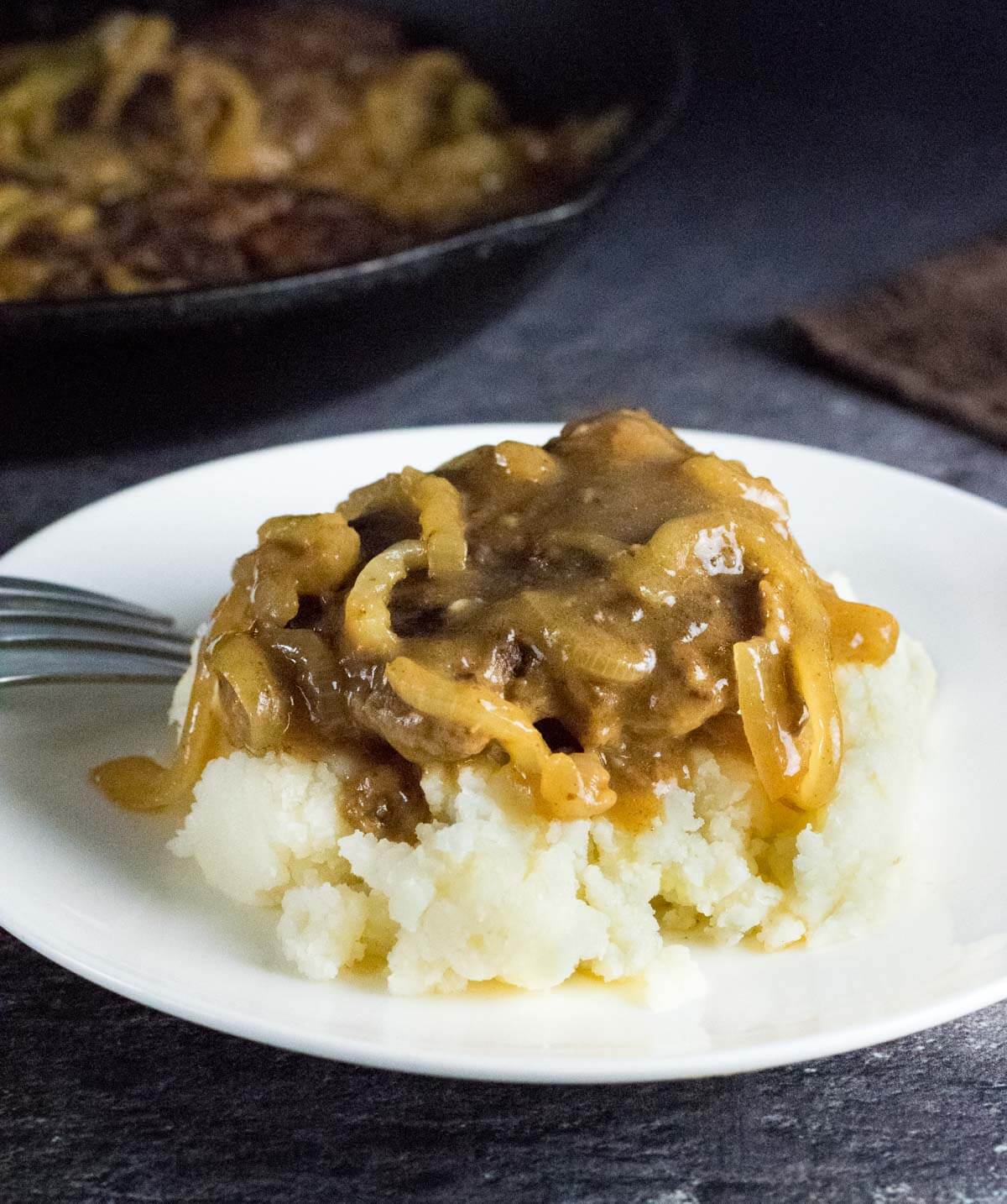 Hamburger steak with gravy on potatoes