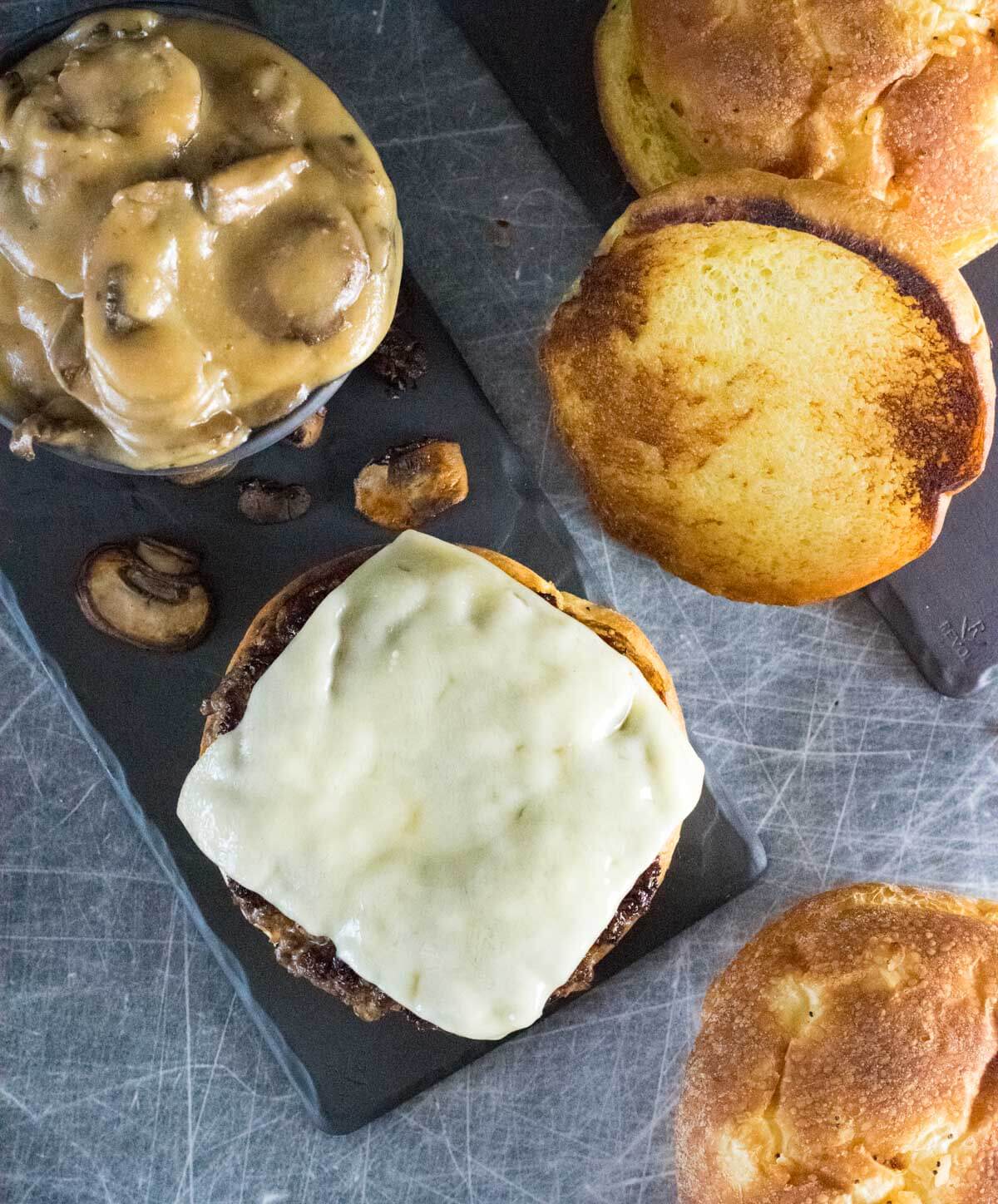 Mushroom burger with melted Swiss cheese and toasted bun viewed from above.