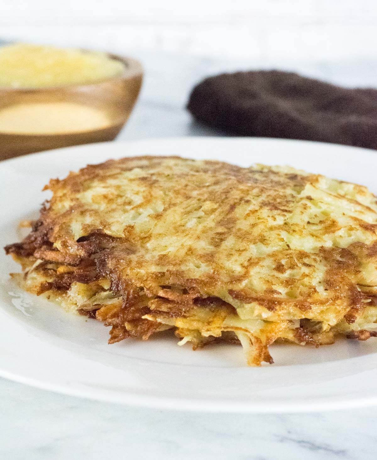 Kartoffelpuffer German Potato Pancakes stacked on a white plate.