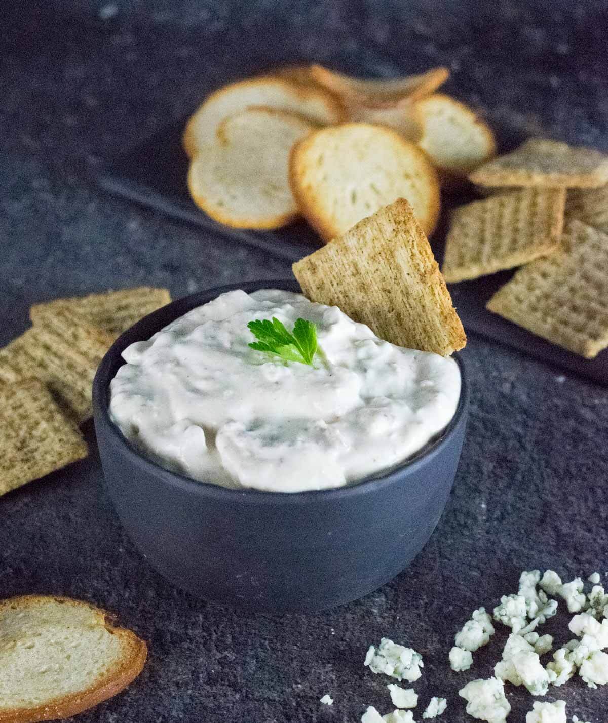 Bacon Horseradish Dip in black bowl with crackers.
