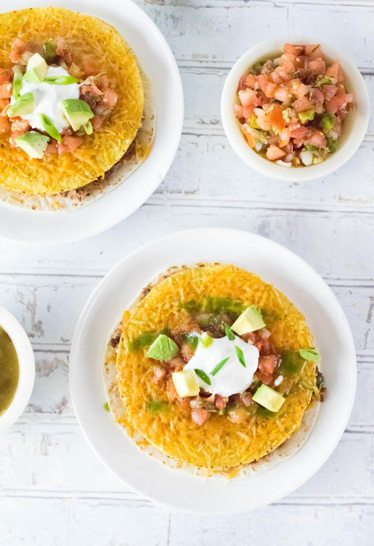 Mexican Pizzas show from above with bowl of pico de gallo.