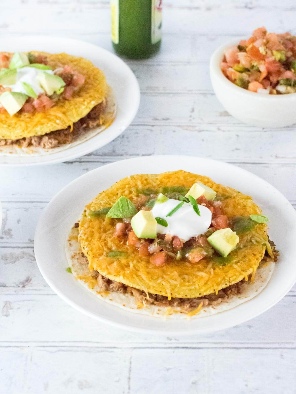 Two Taco Bell copycat Mexican pizzas on white plates.