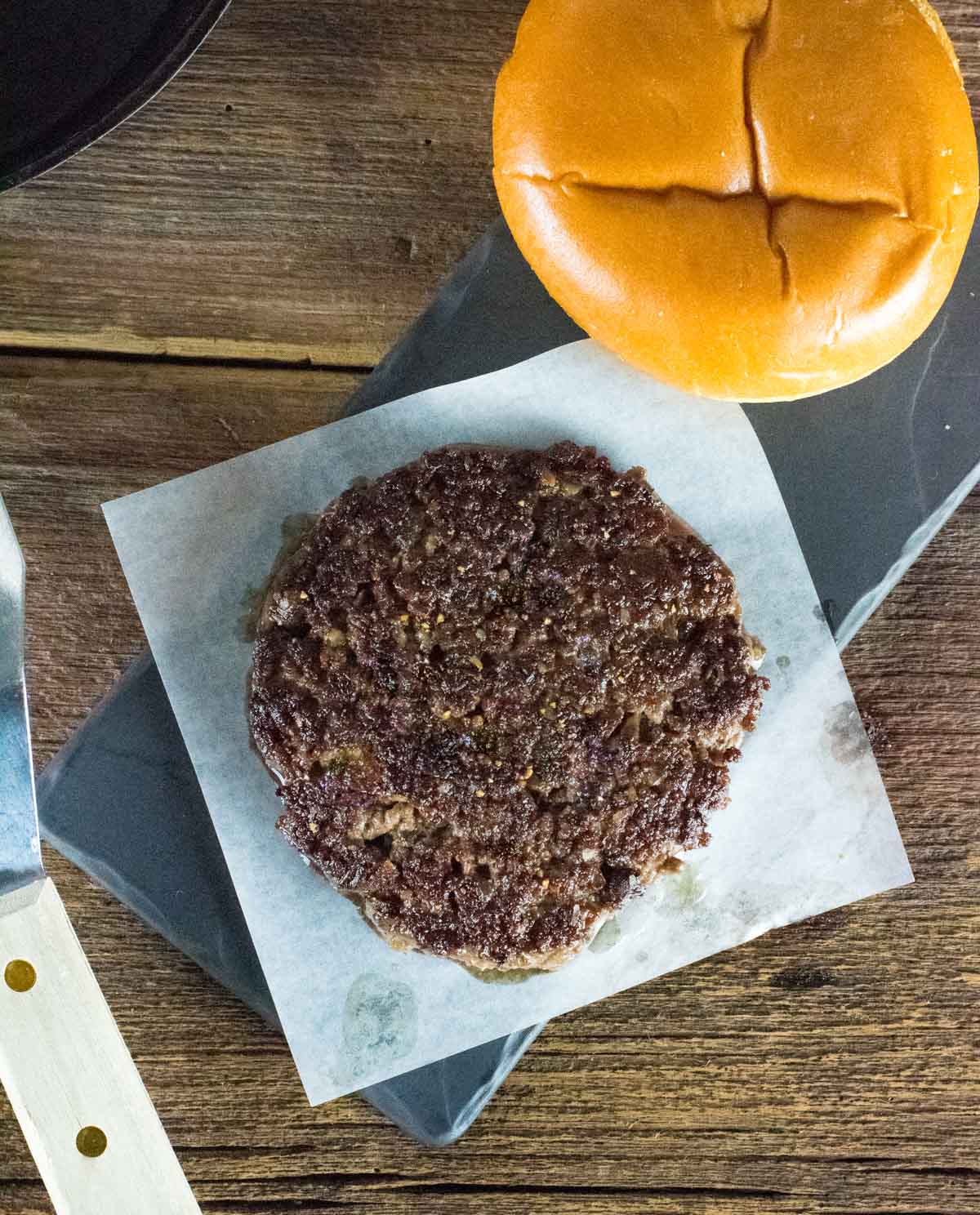 Cooked blended burger patty on wax paper.