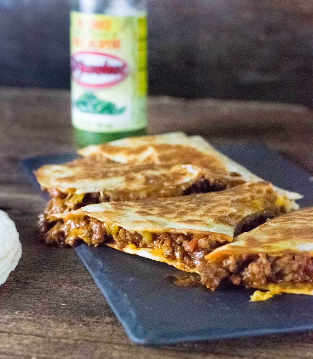 beef quesadillas with cheese dripping out.