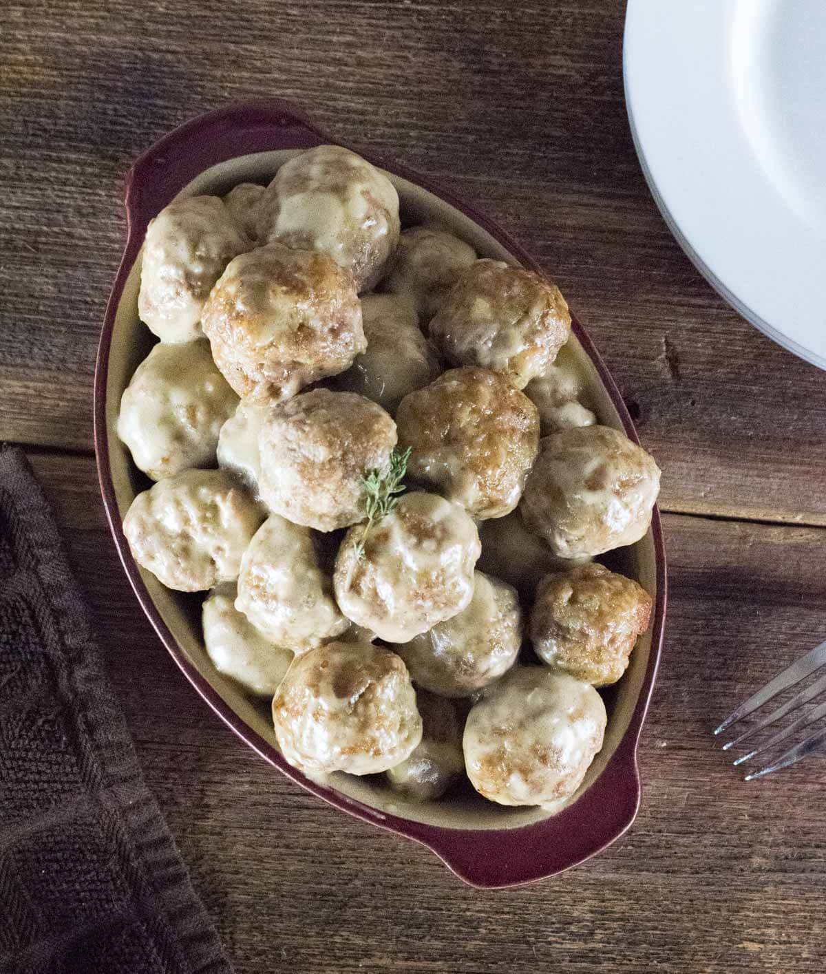 Meatballs and Gravy shown from above in red dish.