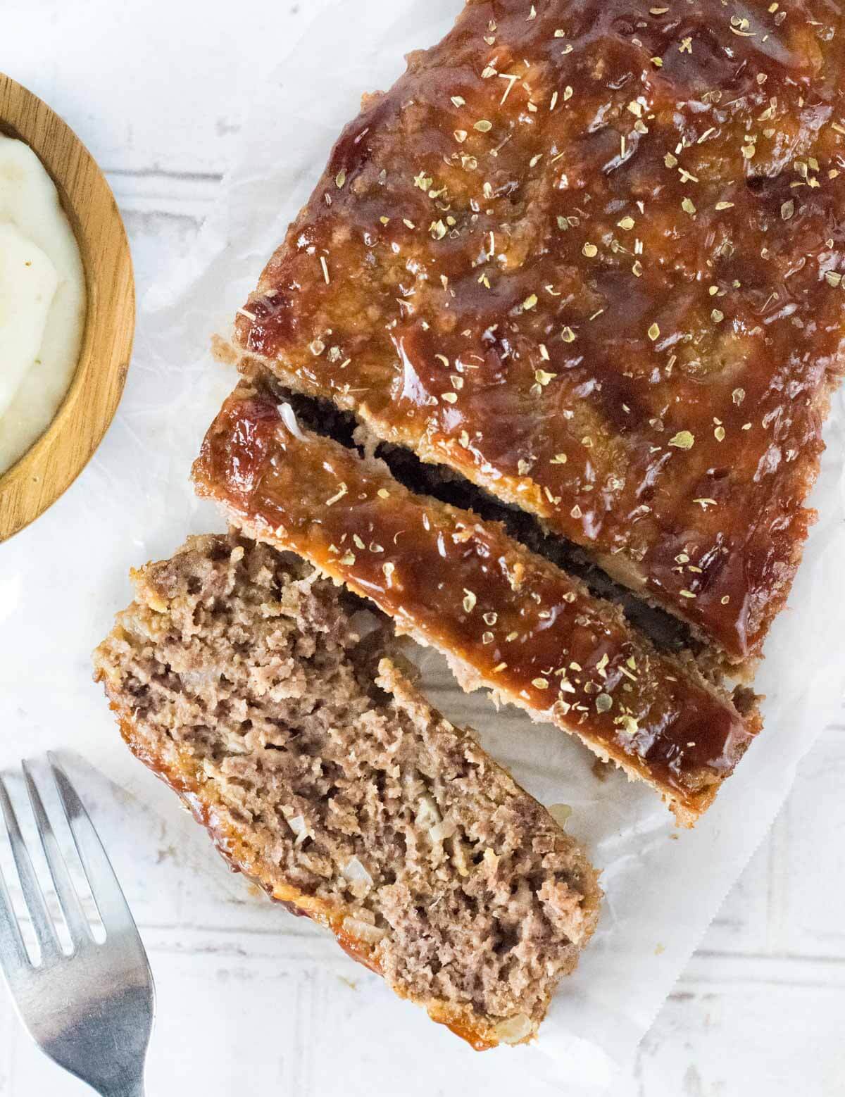 Sliced Sausage Meatloaf on wax paper.