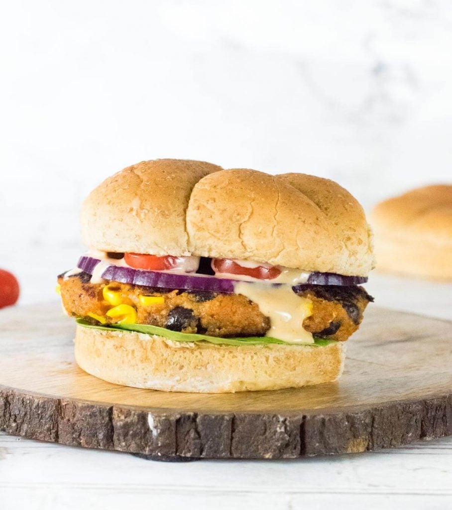 Sweet potato black bean burger on wooden try.