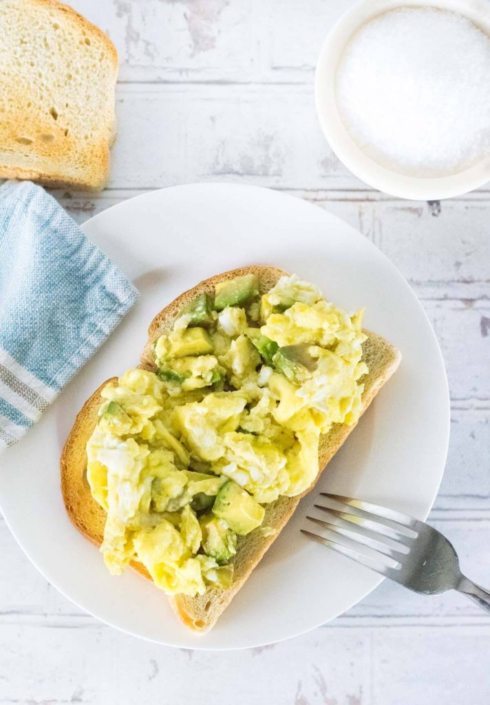 Avocado Scrambled Eggs on sourdough toast shown from above.